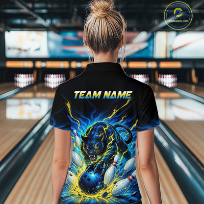 Person wearing a black bowling shirt with a panther design and 'TEAM NAME' text in a bowling alley.