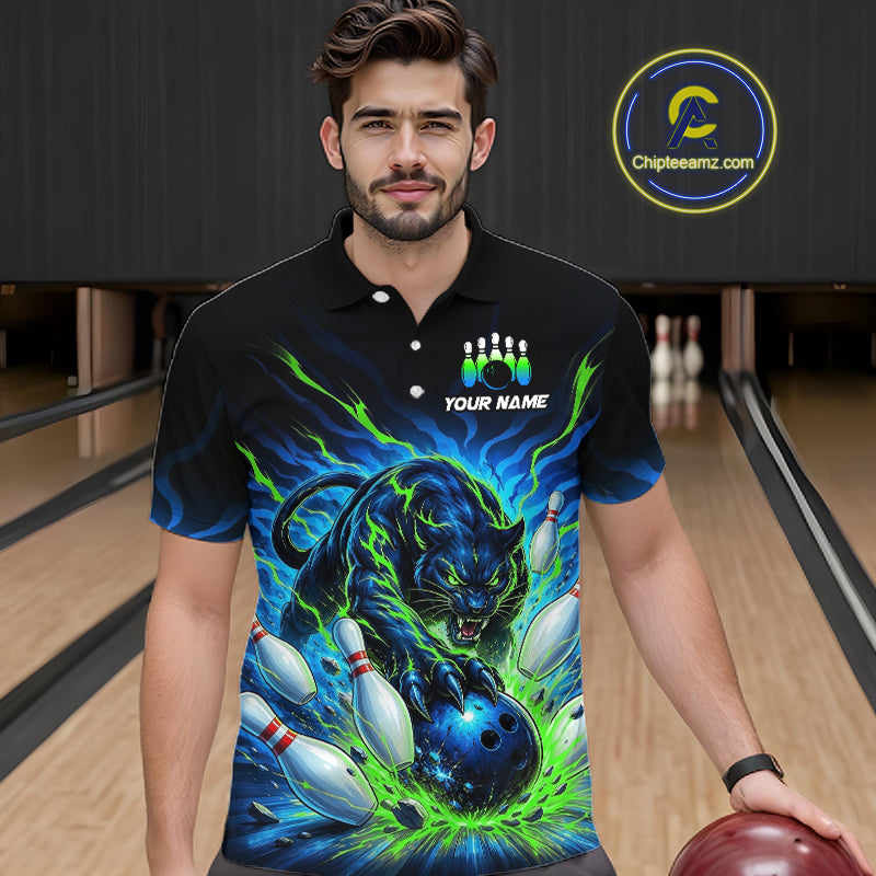 Man wearing a black bowling shirt with a colorful panther design in a bowling alley.