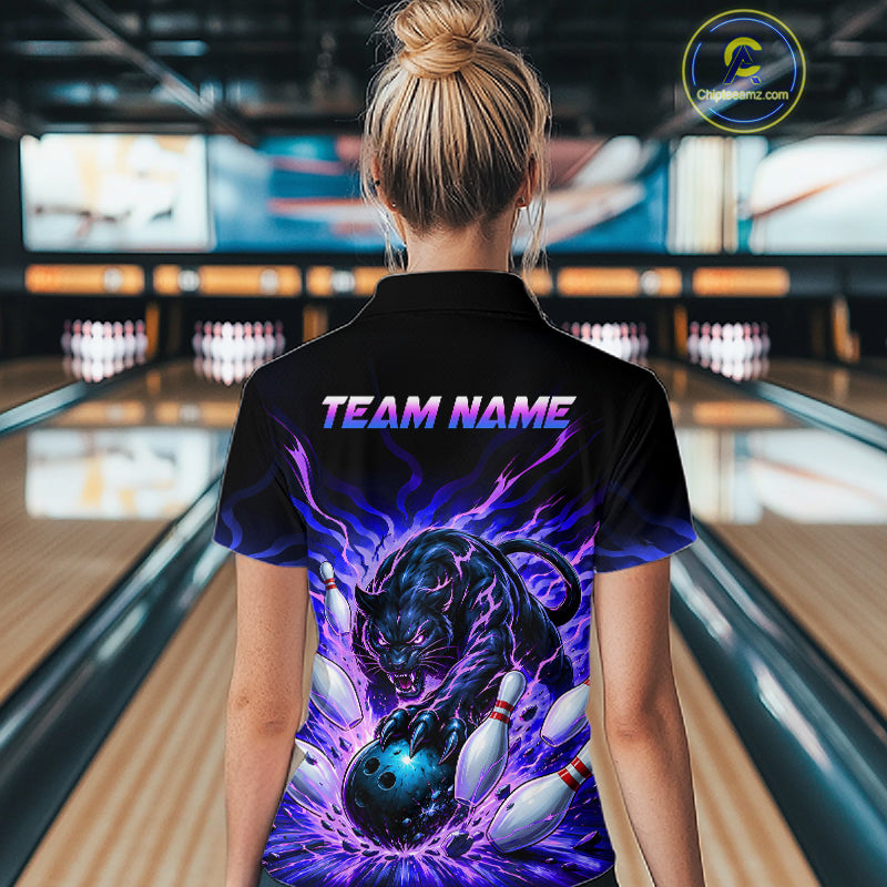 Person wearing a black t-shirt with a panther design and 'TEAM NAME' text in a bowling alley.