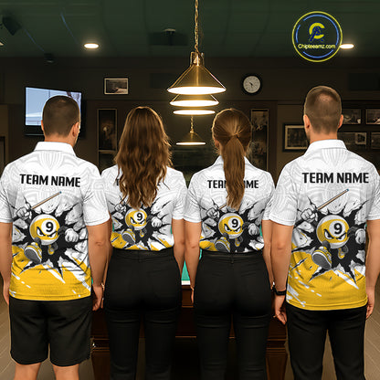 Four people wearing matching biliiard team shirts in a billiard alley.