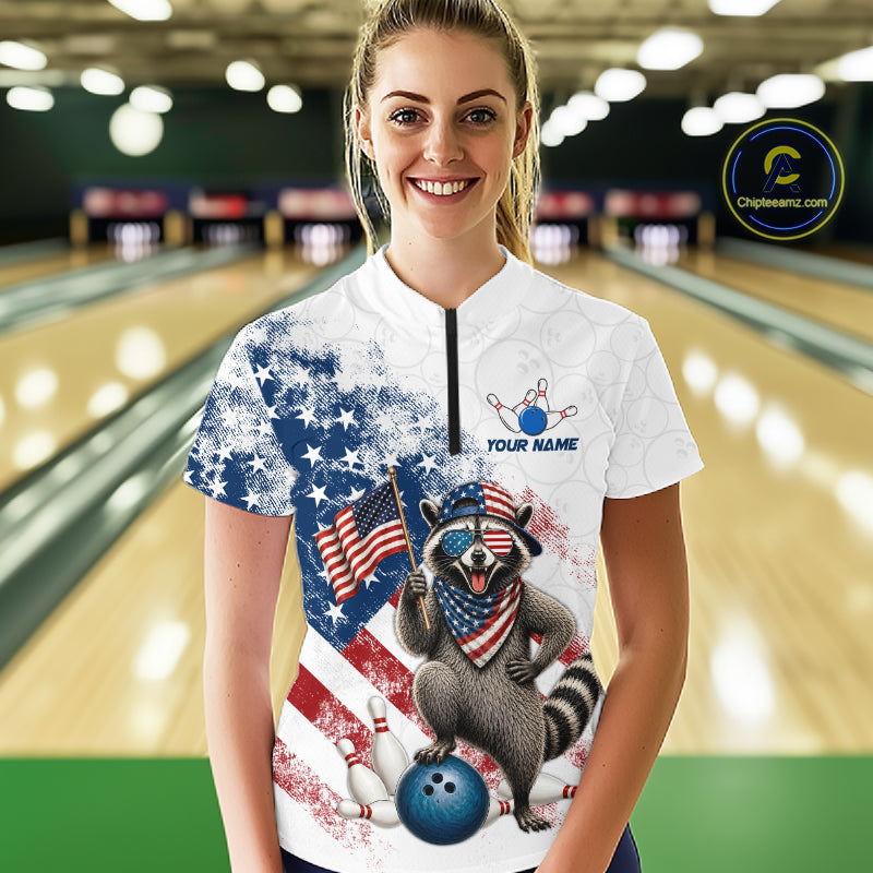 Women’s us flag raccoon bowling quarter zip shirt, front view on female model in bowling lane 