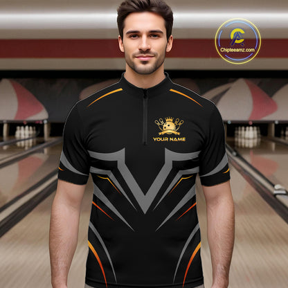 Man wearing a black bowling shirt with a logo and text in a bowling alley.
