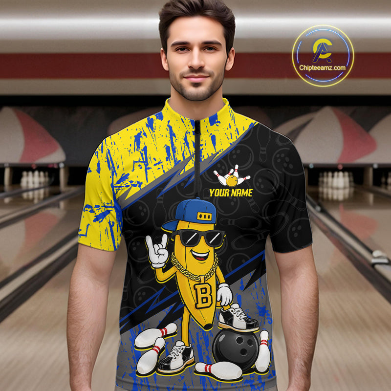 Man wearing a colorful bowling shirt with cartoon character design in a bowling alley.