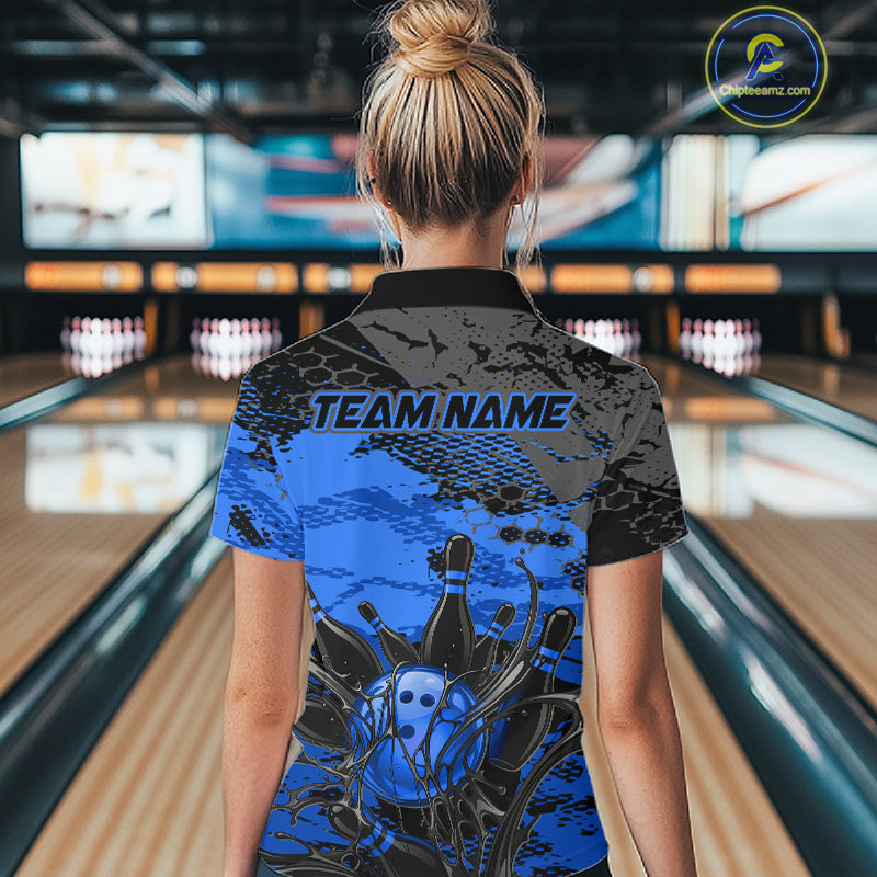 Person wearing a blue and black bowling shirt with 'TEAM NAME' on a bowling alley.