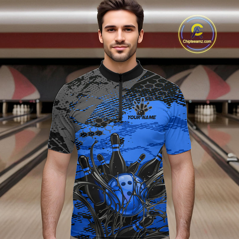 Man wearing a blue and black bowling shirt with a personalized design in a bowling alley.