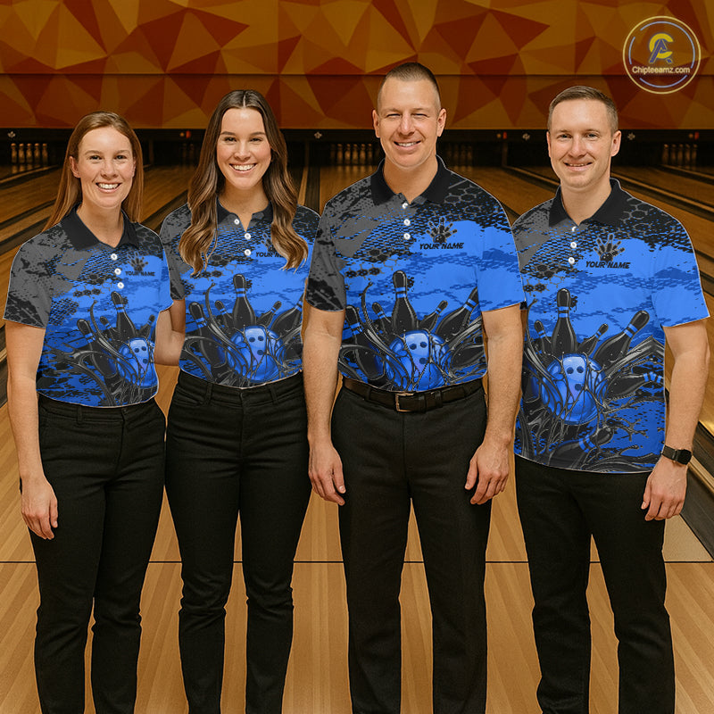 Four people wearing matching blue and black patterned shirts standing on a bowling alley.