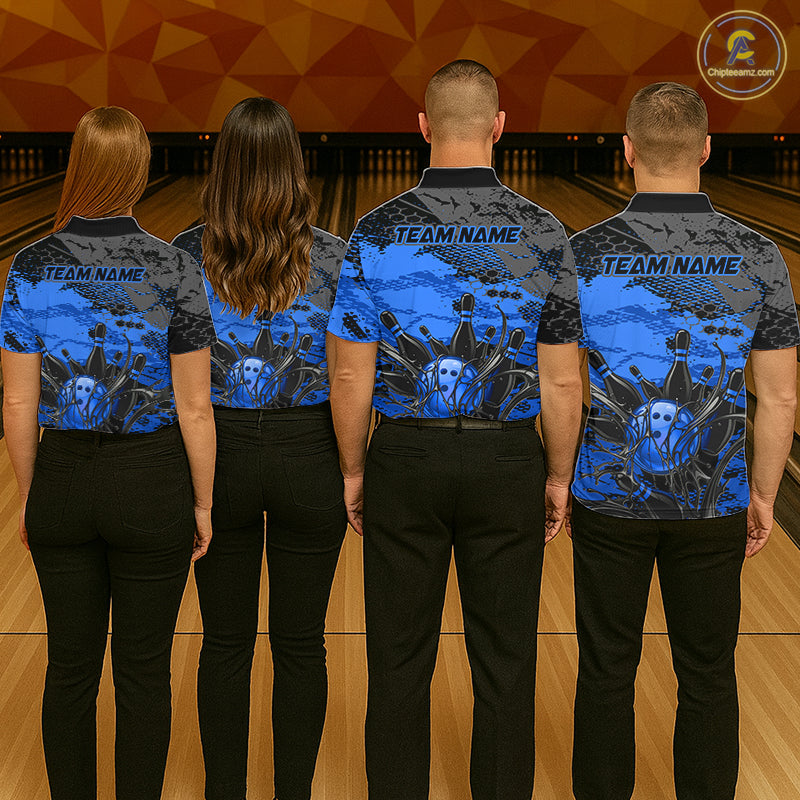 Four people wearing matching blue and black shirts with a design on a bowling alley background
