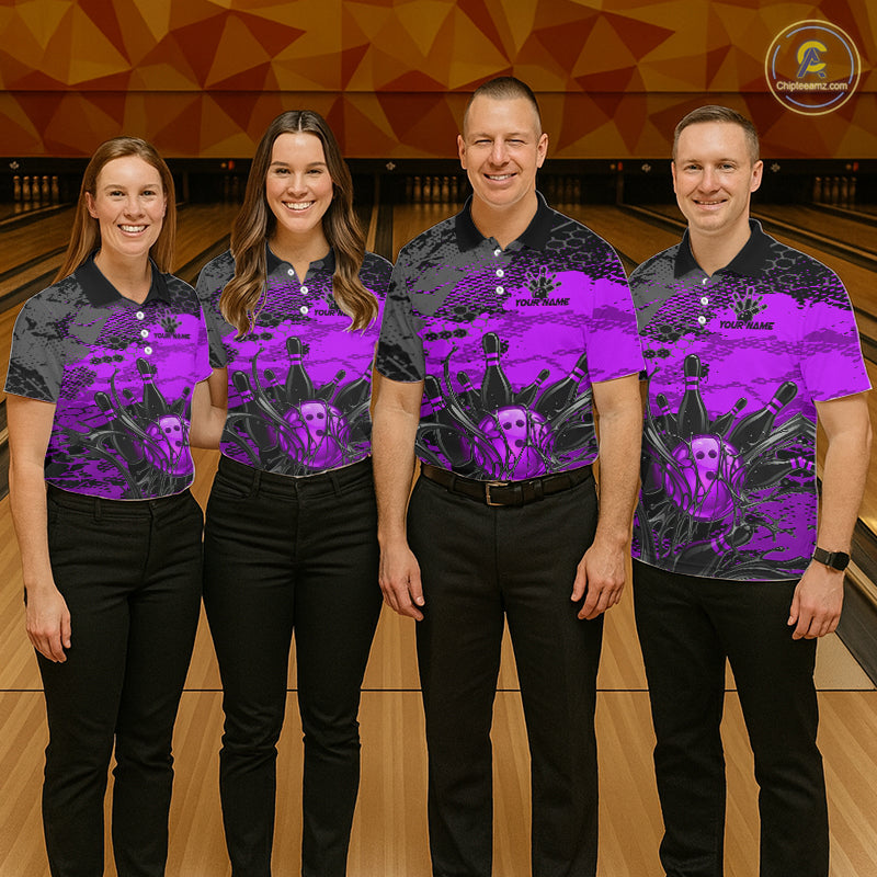 Four people wearing matching purple and black shirts with a skull design on a bowling alley.