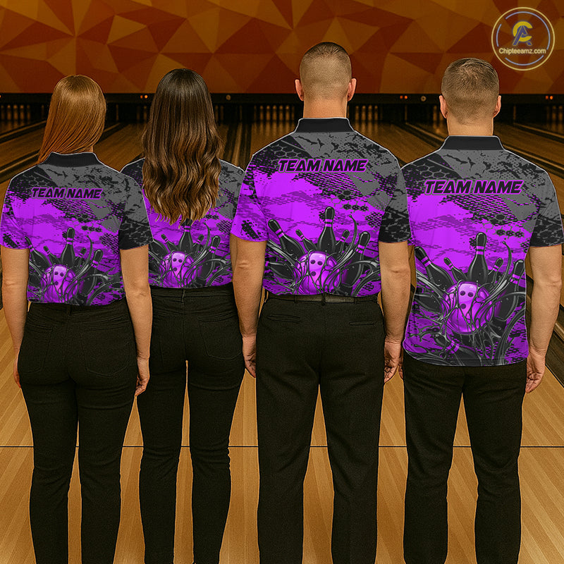 Four people wearing bowling shirts with a purple and black design on a bowling alley.
