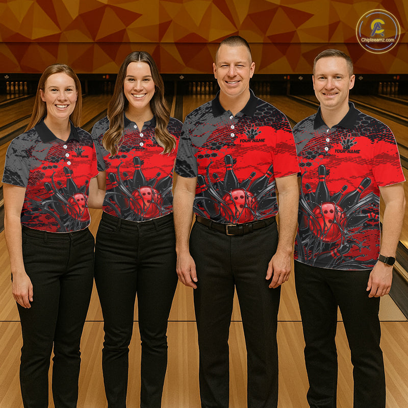 Four people wearing matching red and black shirts with a skull design in a bowling alley.