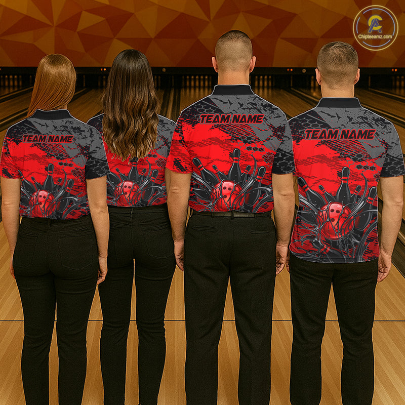 Four people wearing bowling shirts with a red and black design on a bowling alley.