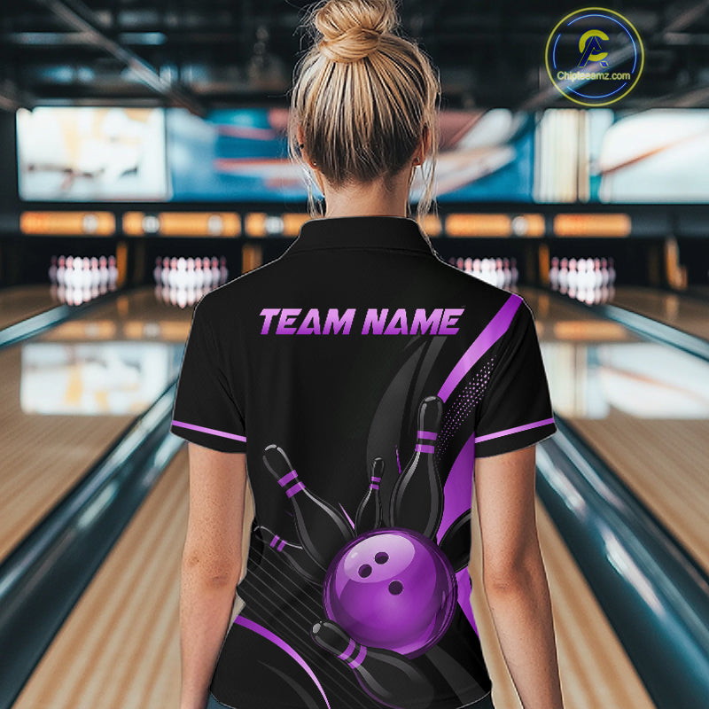 Person wearing a black bowling shirt with a purple bowling ball design and 'TEAM NAME' text in a bowling alley.