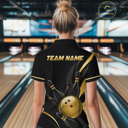 Person wearing a black bowling shirt with 'TEAM NAME' on the back in a bowling alley.