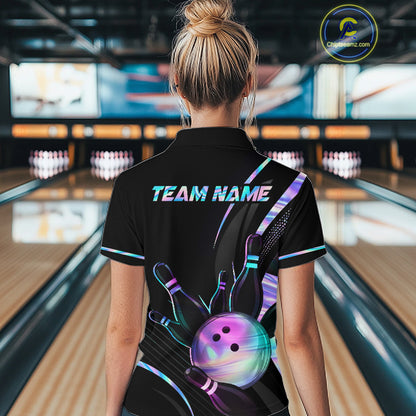 Person wearing a black bowling shirt with colorful designs and 'TEAM NAME' text in a bowling alley.