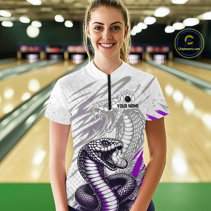 Woman wearing a white t-shirt with a snake design in a bowling alley
