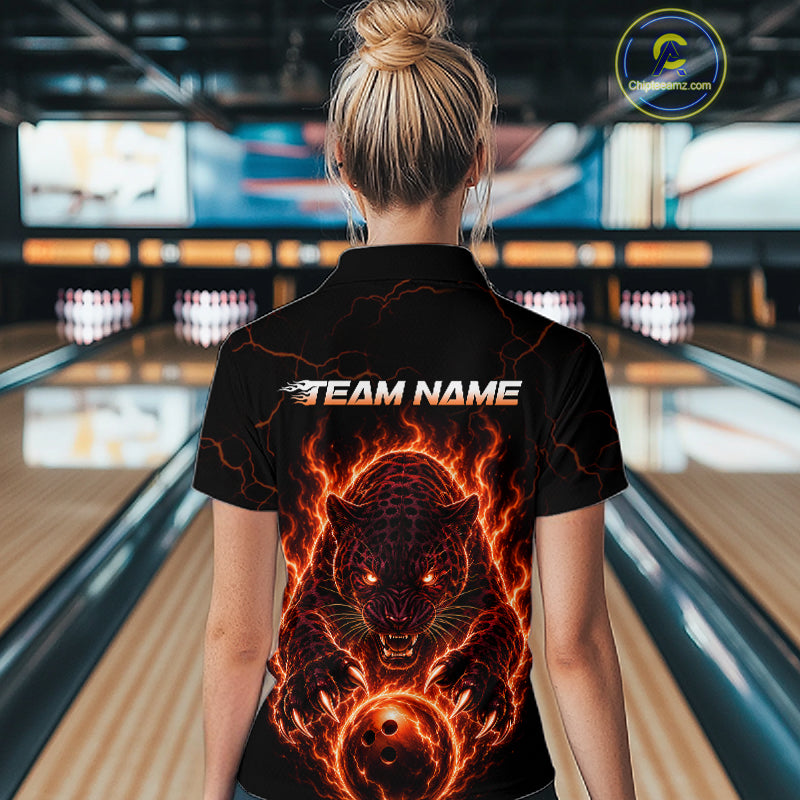 Person wearing a black shirt with a fiery panther design and 'TEAM NAME' text in a bowling alley.