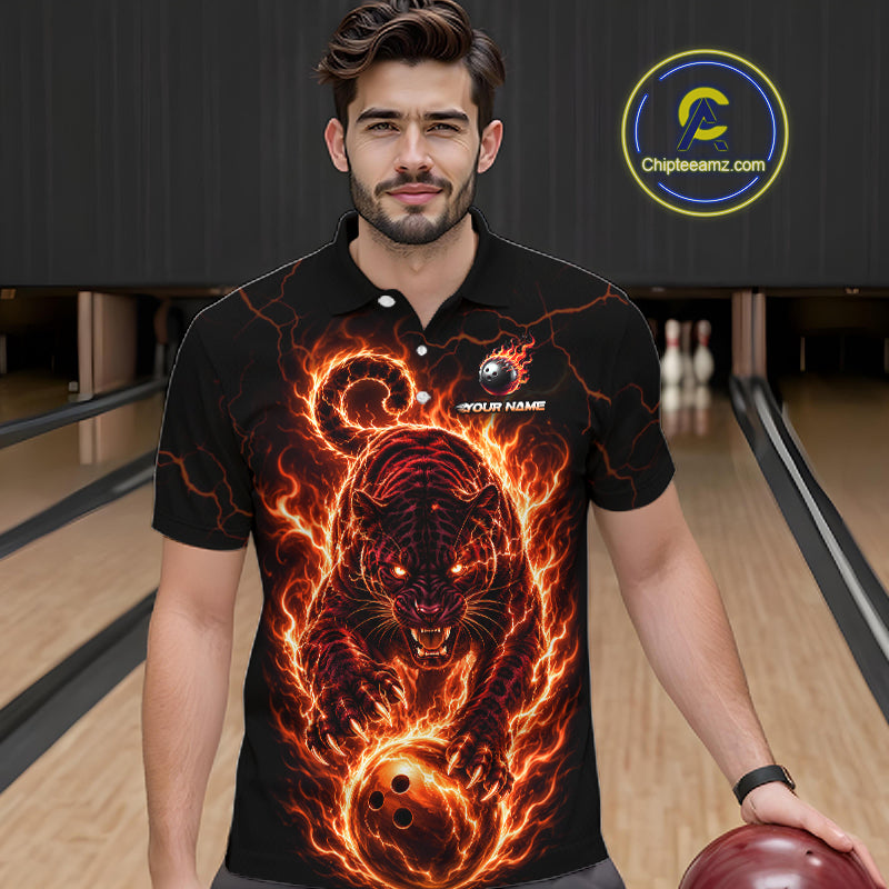Man wearing a black polo shirt with a fiery panther design in a bowling alley.