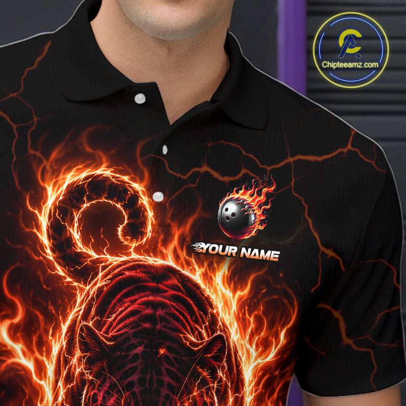 Black polo shirt with fiery design and bowling ball graphic, featuring a brand logo in the corner.