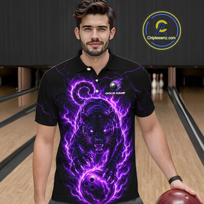 Man wearing a black polo shirt with a purple tiger design in a bowling alley.