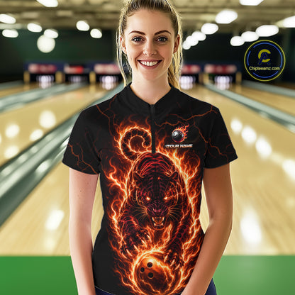 Woman wearing a black bowling shirt with a fiery panther design in a bowling alley.