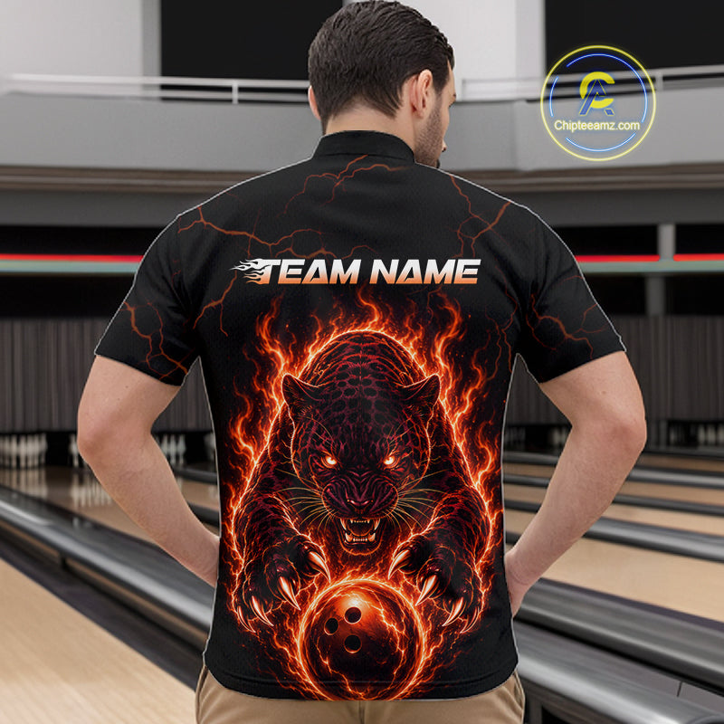 Person wearing a black t-shirt with a fiery panther design and 'TEAM NAME' text on the back, standing in a bowling alley.
