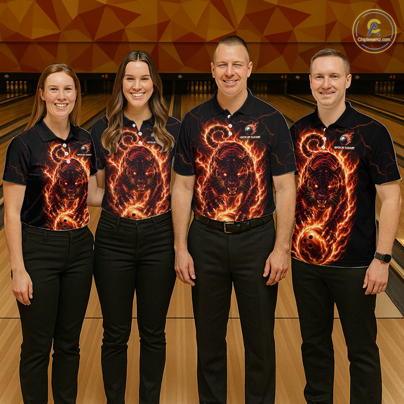 Four people wearing matching shirts with a fiery design on a bowling alley.