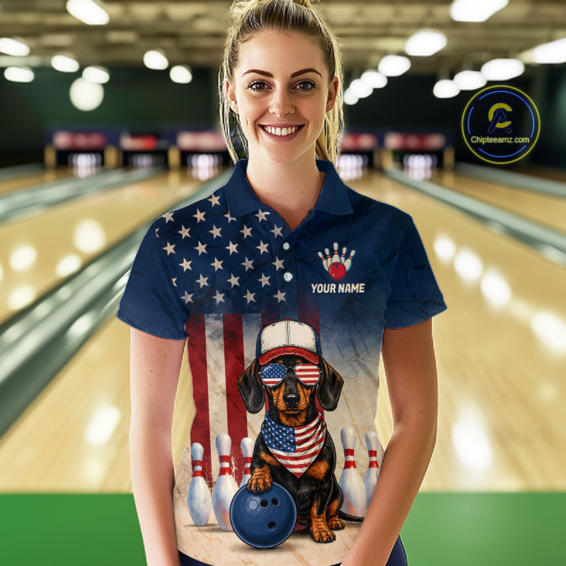 Woman wearing a bowling-themed shirt with a dog design in a bowling alley.