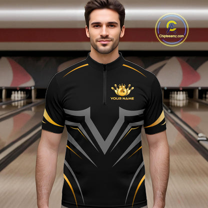 A man wearing a black short-sleeve bowling jersey with gold and gray graphic patterns, standing in a bowling alley. The jersey features a gold crown and trophy graphic with the text 'YOUR NAME' on the chest.