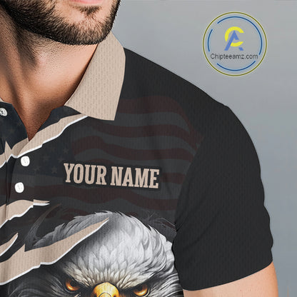 A close-up of a man wearing a black short-sleeve polo shirt with a custom graphic print. The shirt features a beige collar, a torn-paper effect revealing a dark American flag pattern underneath, a bald eagle graphic at the bottom, and the text 'YOUR NAME' in beige.