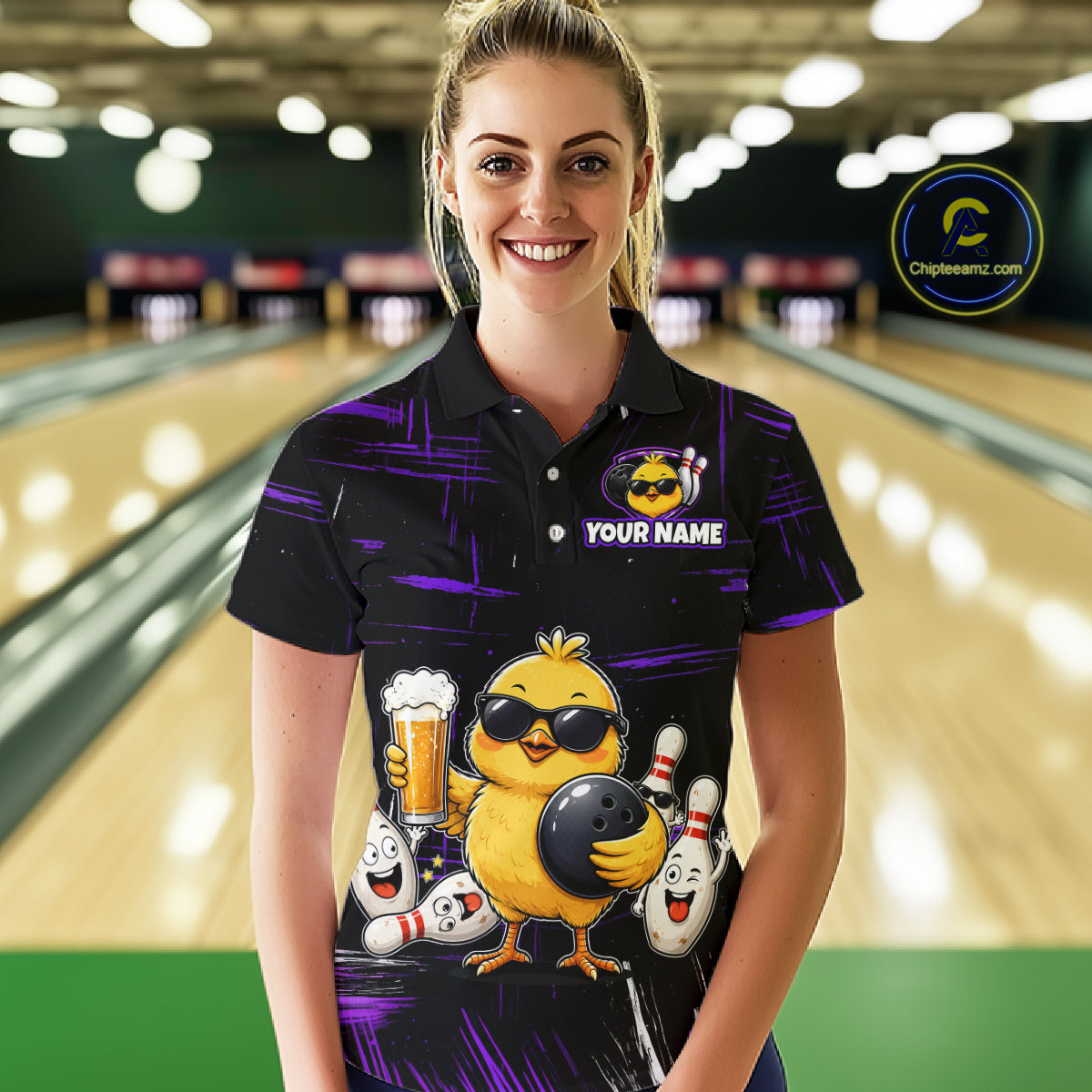 Women wearing bowling polo shirt featuring a chick holding a bowling ball surrounded by smiling pins and beer graphics on black yellow background.