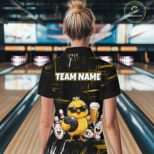 Load image into Gallery viewer, Women wearing bowling quarter zip shirt featuring a chick holding a bowling ball surrounded by smiling pins and beer graphics on black yellow background.