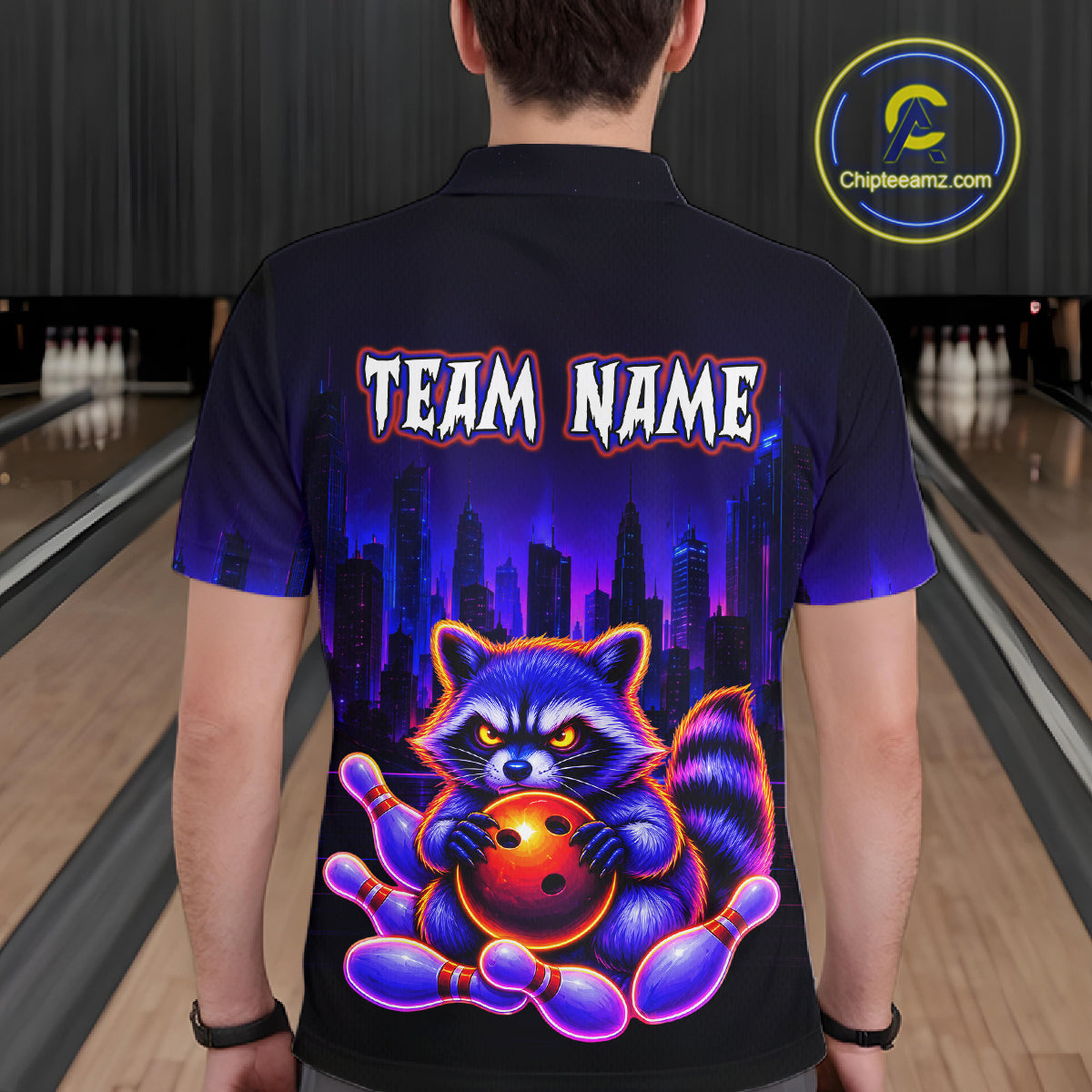 Man wearing bowling polo shirt featuring a raccoon holding a bowling ball framed by pins with purple city skyline background.