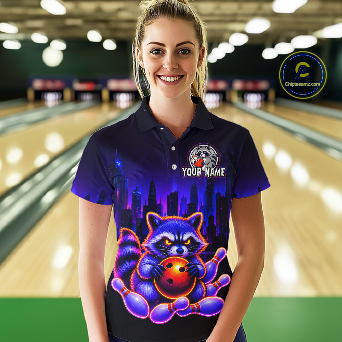 Women wearing bowling polo shirt featuring a raccoon holding a bowling ball framed by pins with purple city skyline background.