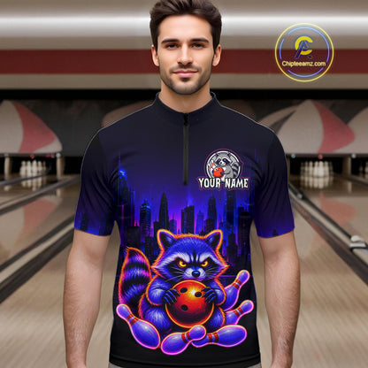 Man wearing bowling quarter zip shirt featuring a raccoon holding a bowling ball framed by pins with purple city skyline background.