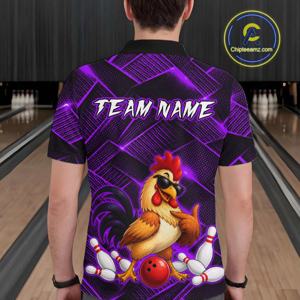 Man wearing a purple and black bowling polo shirt featuring a cool rooster mascot wearing sunglasses, a red bowling ball, bowling pins, and custom team name text.
