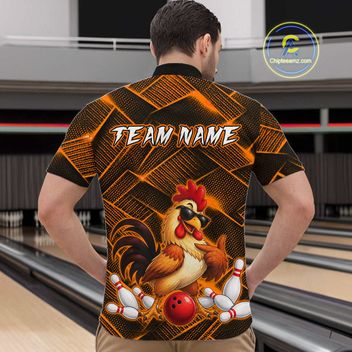 Man wearing a orange and black bowling quarter zip shirt featuring a cool rooster mascot wearing sunglasses, a red bowling ball, bowling pins, and custom team name text.