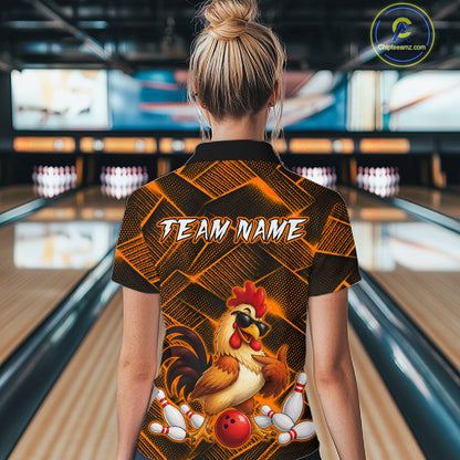Woman wearing a orange and black bowling quarter zip shirt featuring a cool rooster mascot wearing sunglasses, a red bowling ball, bowling pins, and custom team name text.