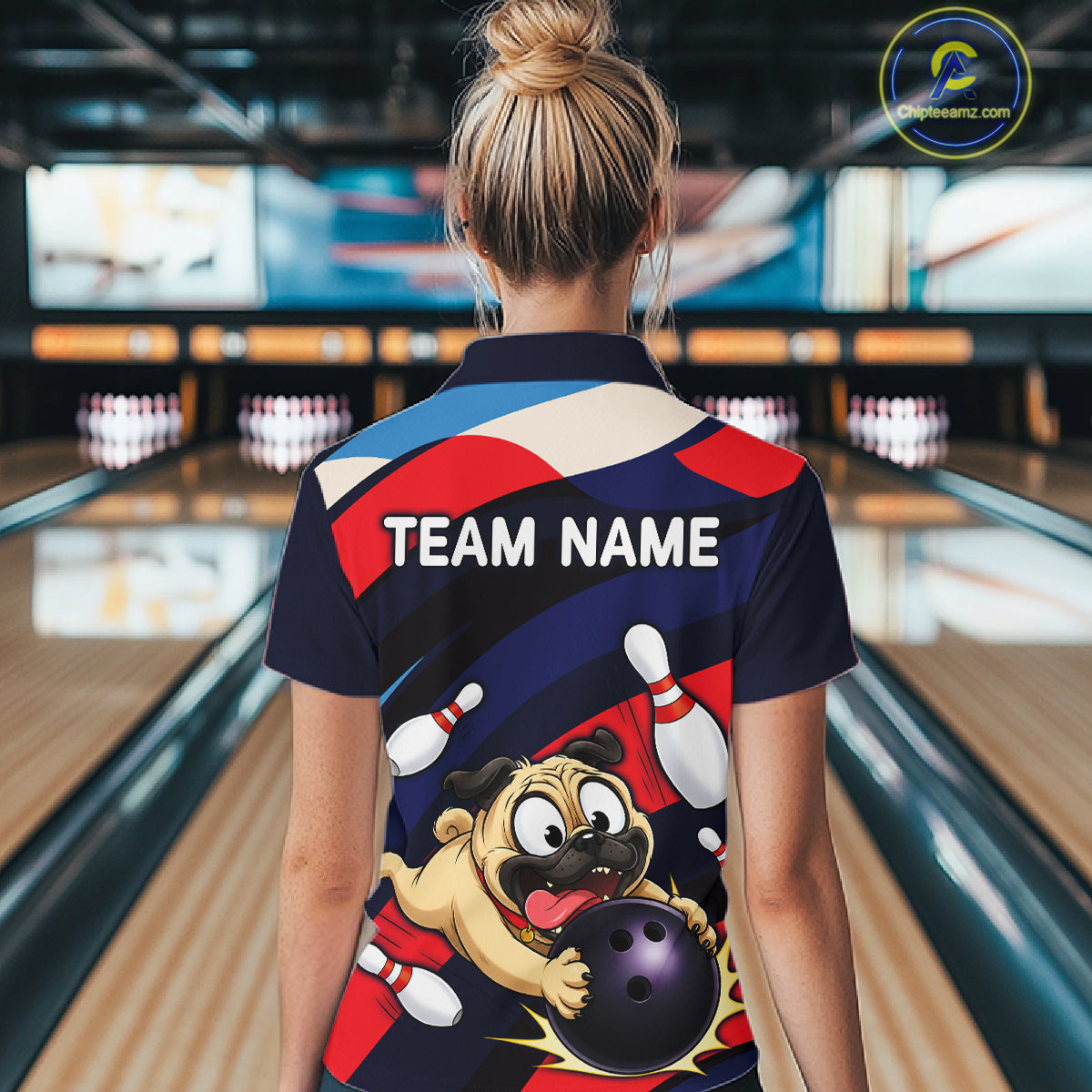 Person wearing a navy, red, and white bowling polo featuring a cartoon pug holding a purple bowling ball, pins, and custom team text.