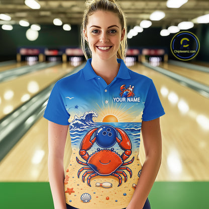 Person wearing a blue polo shirt with a crab design in a bowling alley.