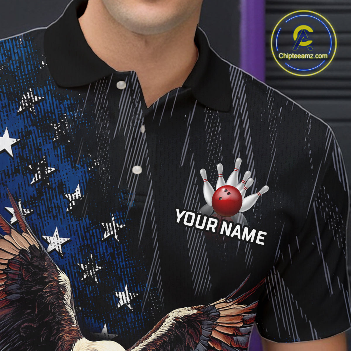 A close-up of a person wearing a black short-sleeve polo shirt with a custom patriotic bowling design. The shirt features a blue and white American flag pattern with stars, a bald eagle graphic at the bottom, and a custom bowling graphic on the left chest showing a red bowling ball and pins with the text 'YOUR NAME'.