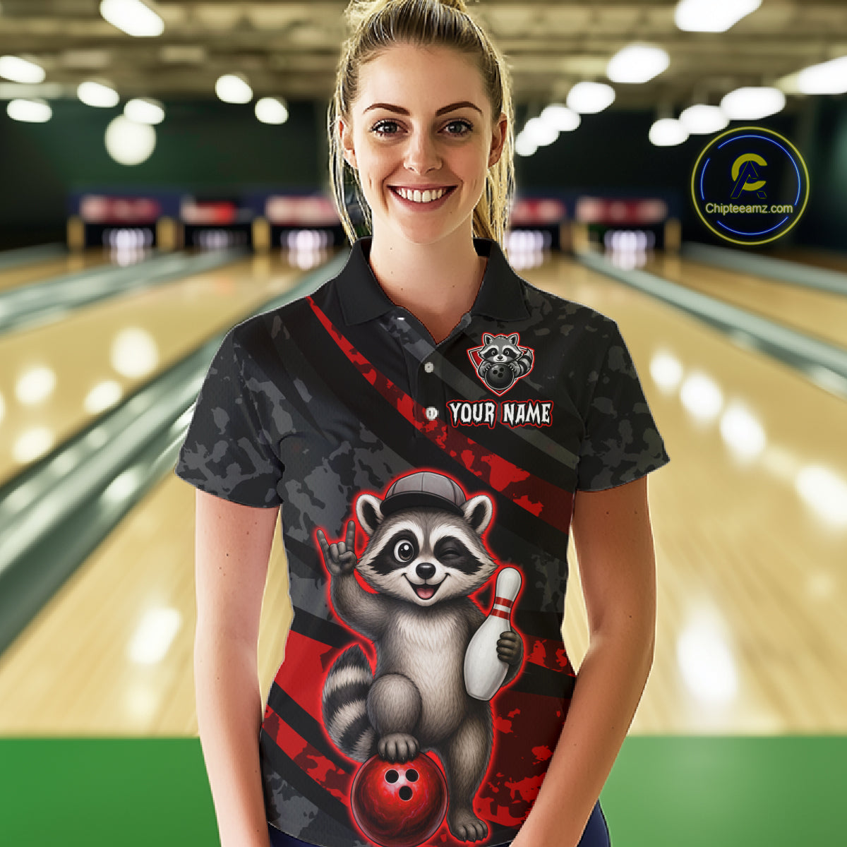 Person wearing a custom bowling shirt with a raccoon design in a bowling alley.
