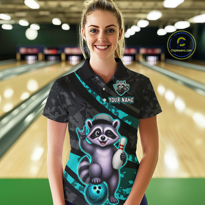 Person wearing a custom bowling shirt with a raccoon design in a bowling alley.