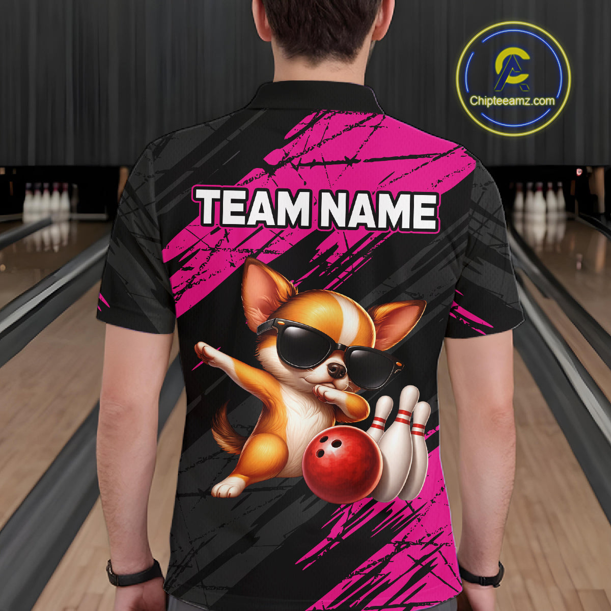 Person wearing a bowling shirt with a dog graphic and 'TEAM NAME' text in a bowling alley.