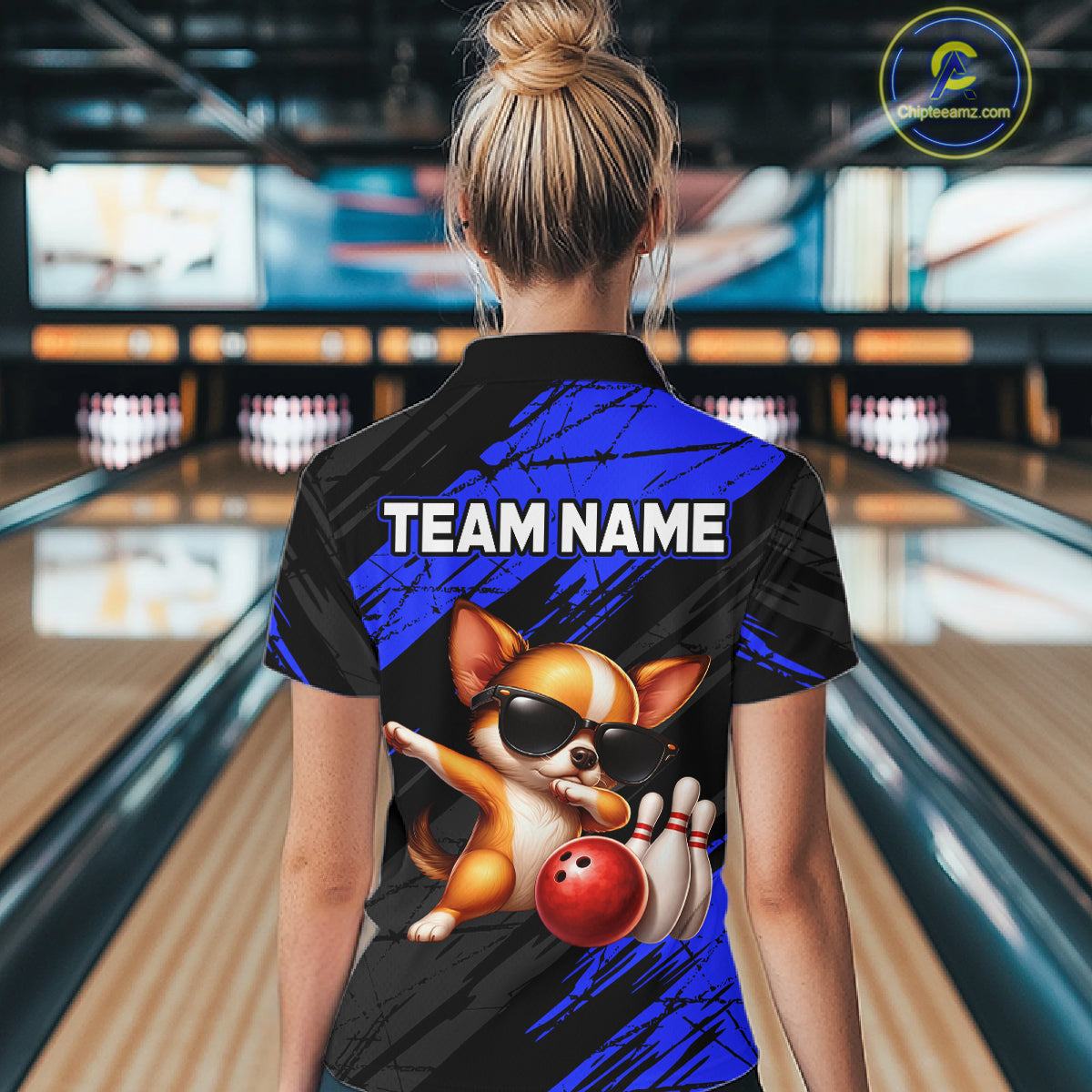 Person wearing a bowling shirt with a dog graphic and 'TEAM NAME' text in a bowling alley.