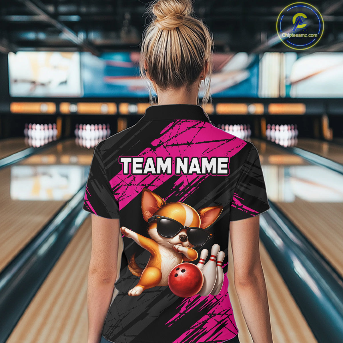 Person wearing a bowling shirt with a dog graphic and 'TEAM NAME' text in a bowling alley.