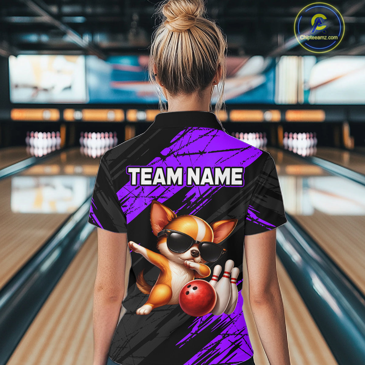 Person wearing a bowling shirt with a dog graphic and 'TEAM NAME' text in a bowling alley.