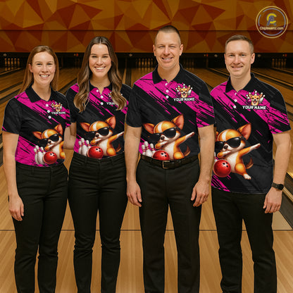 Four people wearing matching bowling shirts with a dog design on a bowling alley.