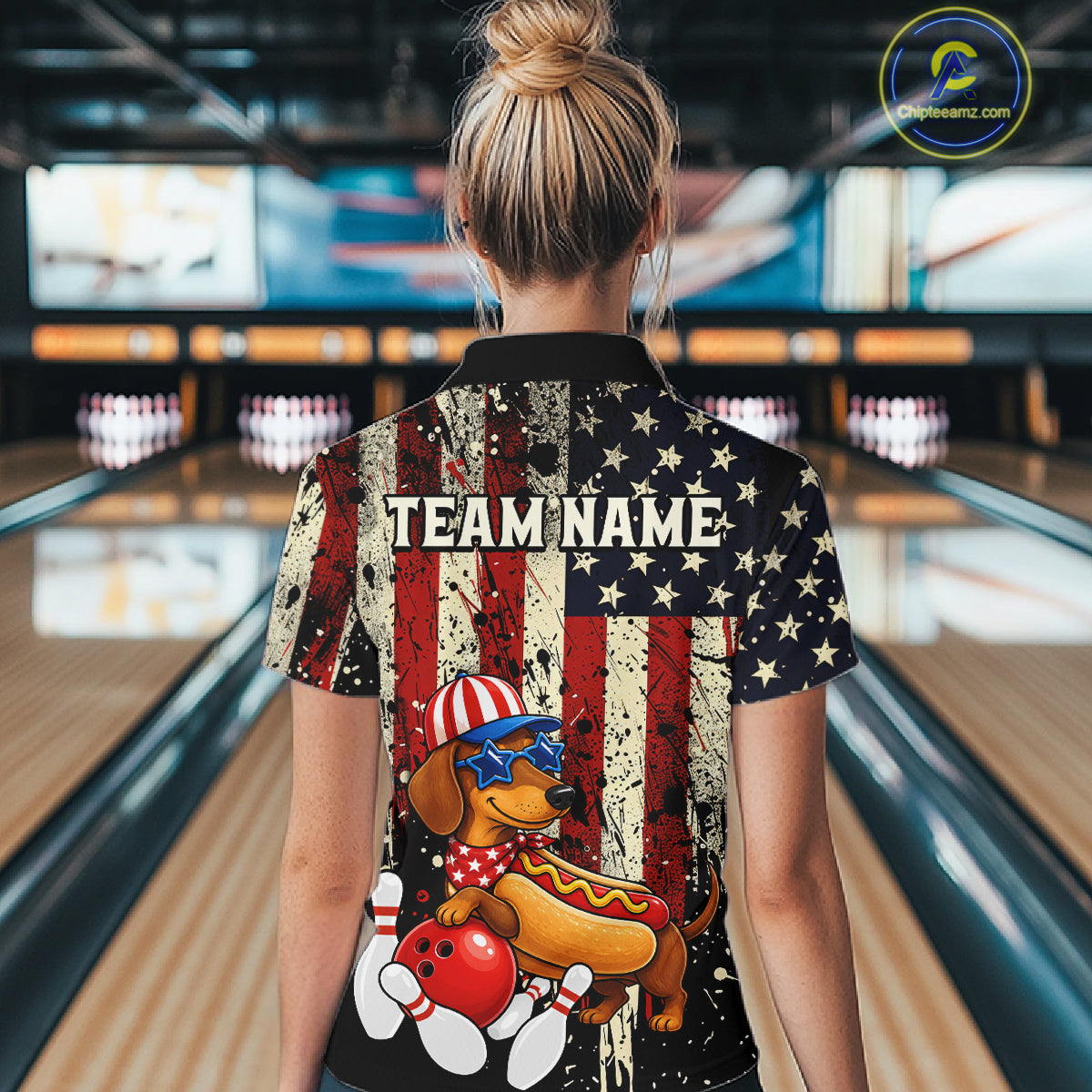 Person wearing a shirt with a dachshund and American flag design in a bowling alley.