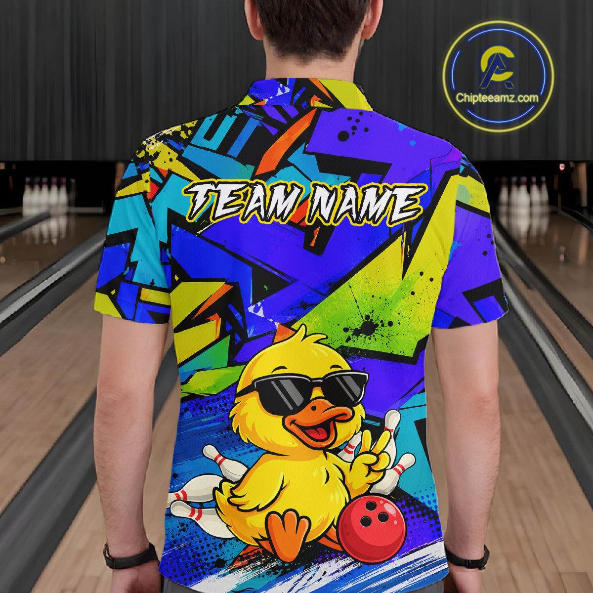 Men wearing a vibrant blue bowling polo featuring a cartoon duck in sunglasses, bowling pins, a red bowling ball, and personalized name and team name text.