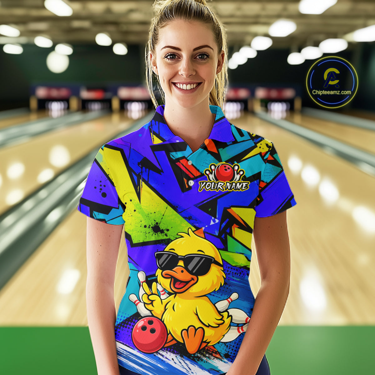 Person wearing a colorful bowling shirt with a duck graphic in a bowling alley.